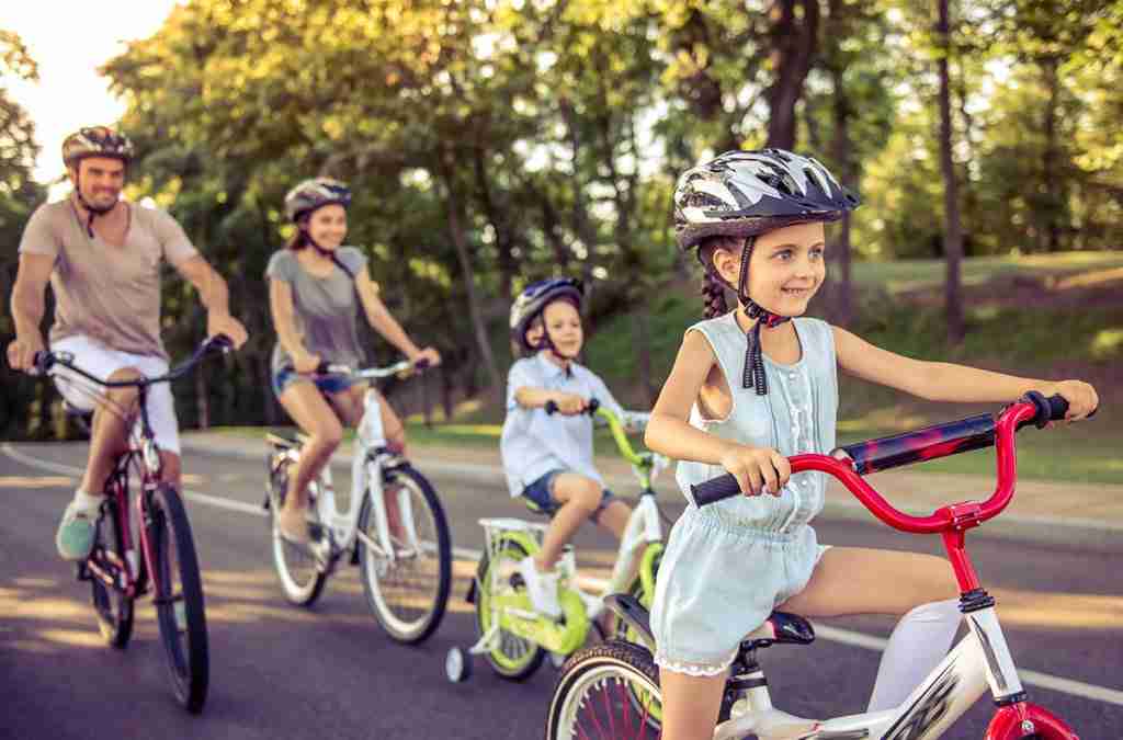 child-safety-family-with-two-children-riding-bikes