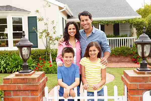 long-island-real-estate-lawyer-parents-and-children-standing-outside-home